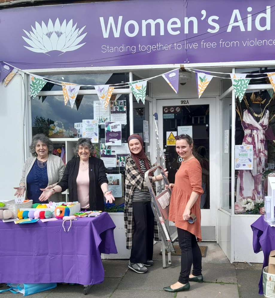 image of staff and volunteers outside charity shop