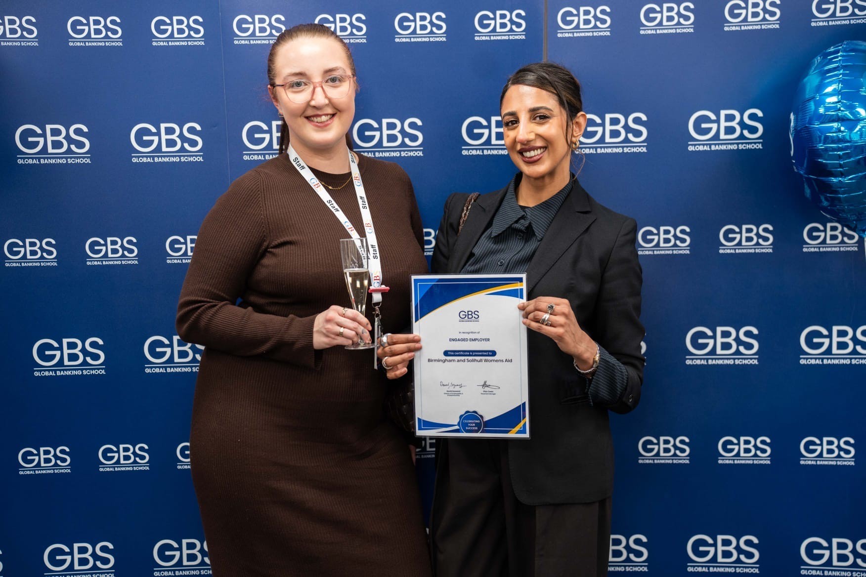 Image of BSWA female and GBS female smiling holding an award certificate